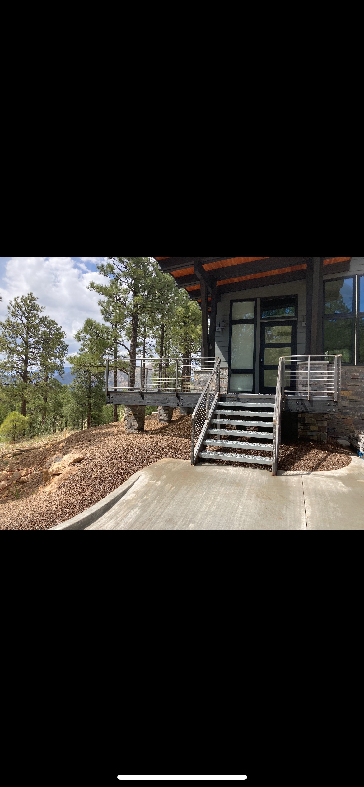 Modern deck with metal stairs and railings